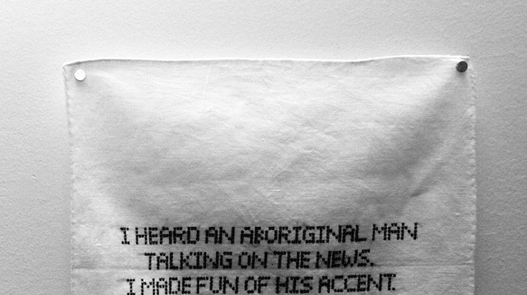 One of Tamara Huxtable's hankies embroidered with the confession "I heard an aboriginal man talking on the news. I made fun of his accent."