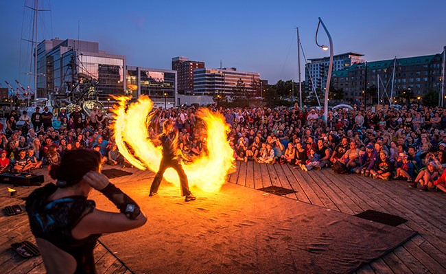 Fire eaters spinning flames at Buskerfest.