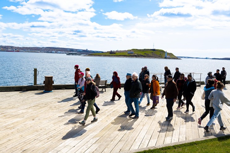 Jane's Walk participants take a stroll along the Halifax boardwalk.