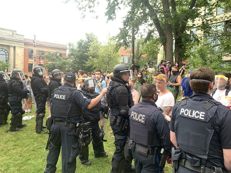 Police push back against protesters on the old library lawn on Wednesday, Aug. 18, 2021. The HRM's removal of tents and wooden structures from parks across Halifax prompted widespread outrage.