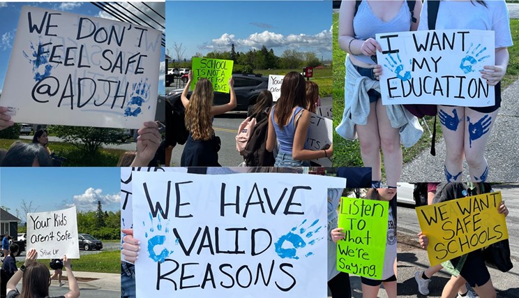 Student signs at Friday's walkout. Blue paint was used to show solidarity with Grade 9 student, Claire Kelly, who was injured at the school on Tuesday, May 28. Blue is Kelly's favourite colour.